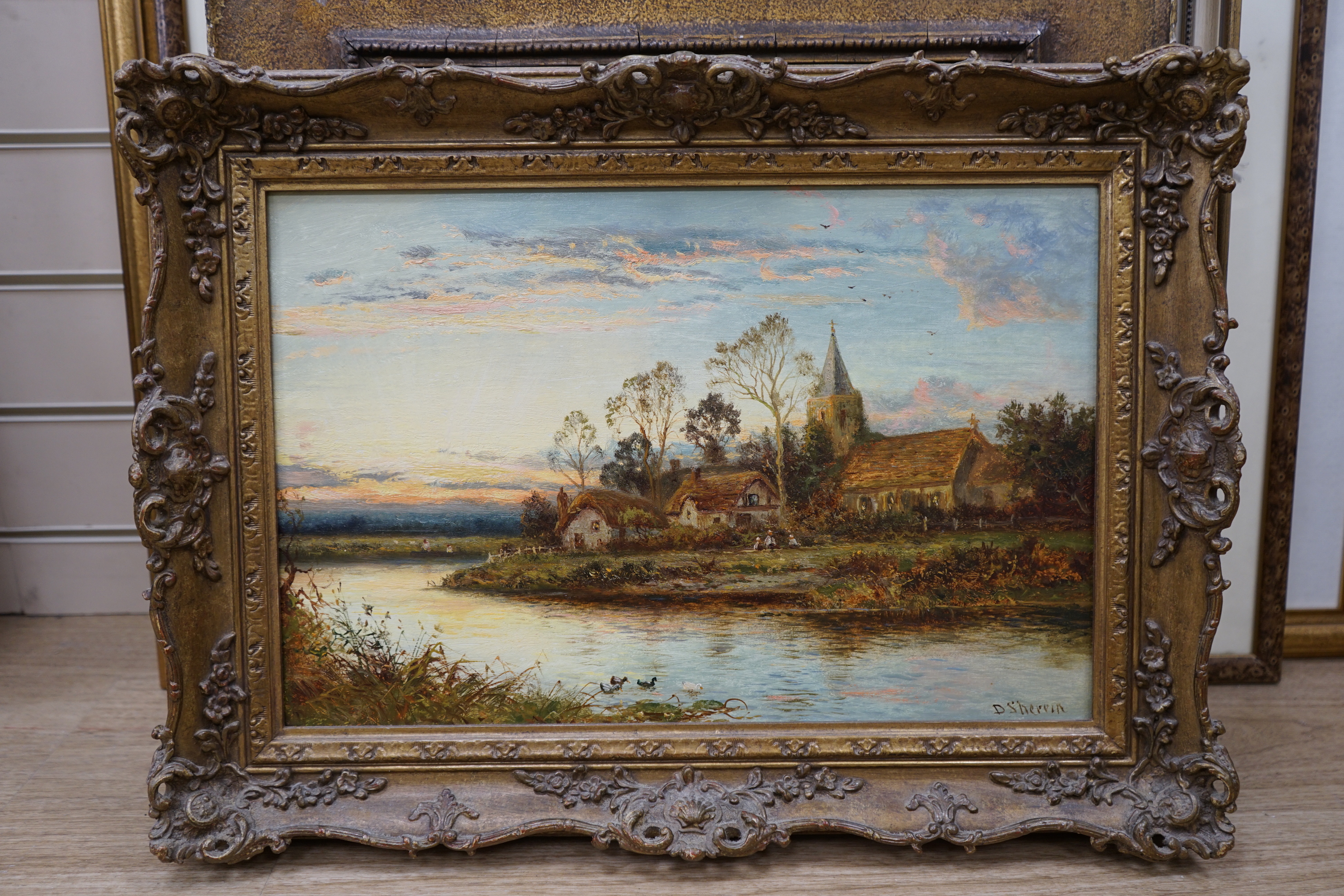 Daniel Sherrin (1868-1940), oil on canvas, River landscape with church and cottages, signed, 29 x 44cm